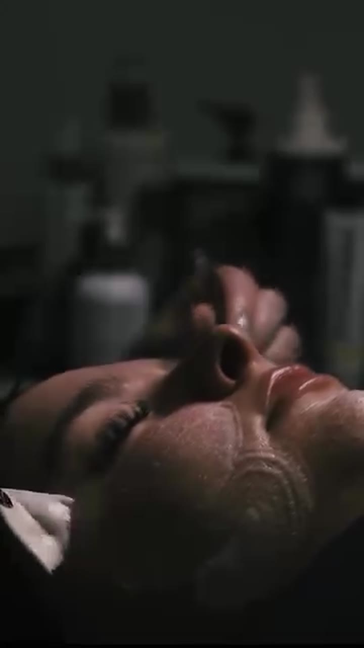 An esthetician applying a facial treatment in a client brand film