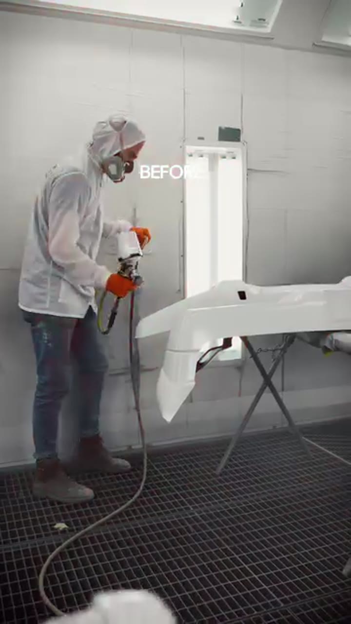 An automotive specialist preparing a car panel for painting